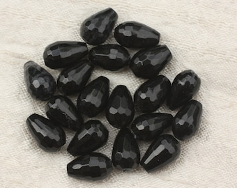 May include: A collection of black faceted teardrop-shaped beads. The beads are made of a smooth, polished material and have a glossy finish.