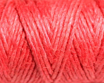 May include: Close-up of a spool of bright red twine. The twine is made of natural fibers and has a rough texture.