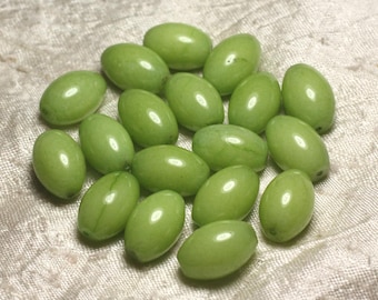May include: A collection of 17 green oval-shaped beads. The beads are smooth and glossy, with a light green color.