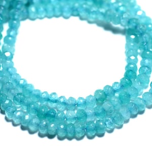 May include: A strand of light blue aquamarine beads, faceted and round, strung together in a necklace.