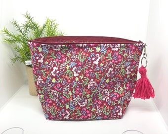 Pink floral makeup bag with lined travel toiletry and pompom