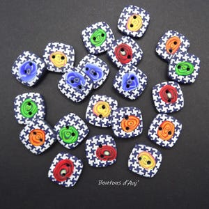 May include: A selection of square buttons with a navy and white houndstooth design. Each button has a colourful spiral centre in red, orange, yellow, green, and blue. The text "Boutons d'Auj" is visible.