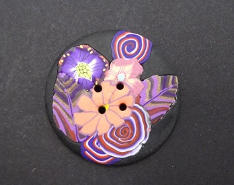 Fancy sewing button with flowers on black background 4 cm (1.57")