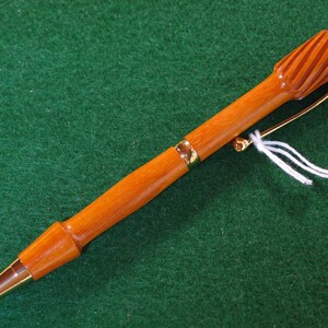 Handmade wooden twist style ballpoint pen with an extra twist in Pernambuco wood