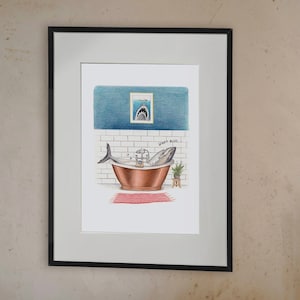 May include: A white bathtub with a black faucet and a black side table. A framed illustration of a shark in a bathtub with the text "Don't Panic" is hanging on the wall.