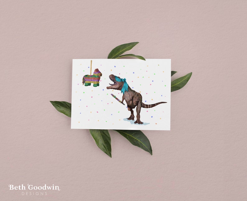 May include: A greeting card featuring a cartoon dinosaur wearing a blindfold and holding a stick, about to hit a colorful pinata. The background is white with confetti.