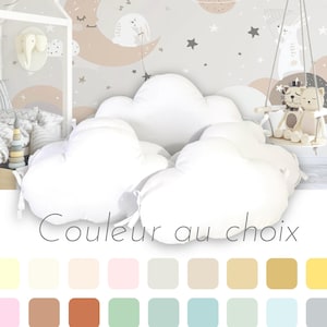 May include: A collection of white cloud-shaped pillows arranged in a group. Below the pillows, the text "Couleur au choix" is displayed, followed by a grid of twenty-four distinct solid colour squares representing available colour options for the pillows.