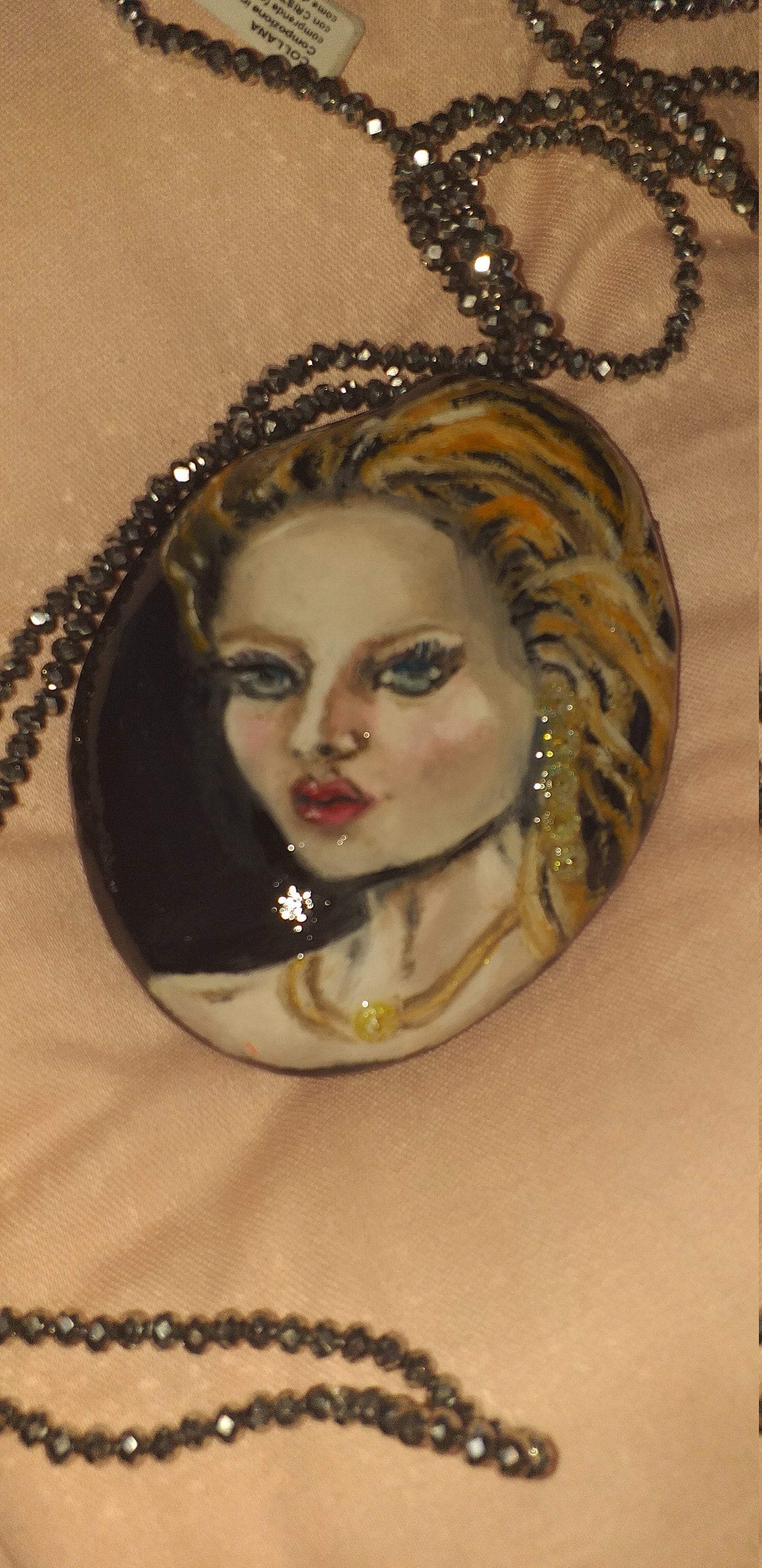 Portrait of woman executed in oil colors on rock collected along the seashore