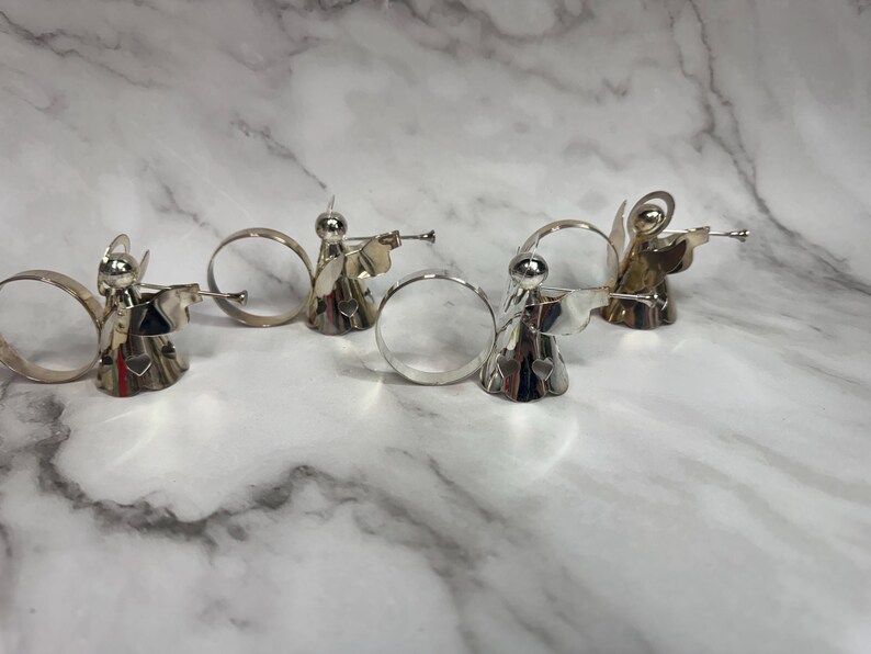 May include: A set of three ceramic mugs with a speckled, matte finish. The mugs are in shades of cream, light gray, and dark gray. Each mug has a simple, minimalist design, perfect for coffee or tea.