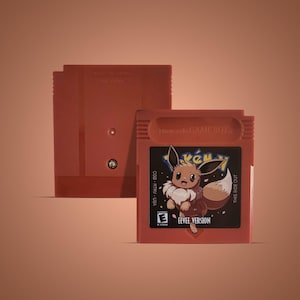 May include: A red Game Boy Color cartridge with a black label featuring a cartoon Eevee from the Pokemon franchise. The label reads "Pokemon" and "Eevee Version". The cartridge is labeled "Nintendo Game Boy" and "CGB-RTRV-USA".