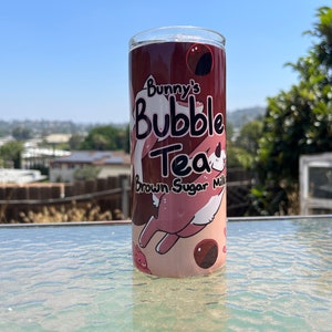 May include: A pink and brown tumbler with a cartoon bunny and the text "Bunny's Bubble Tea Brown Sugar Milk" printed on it.