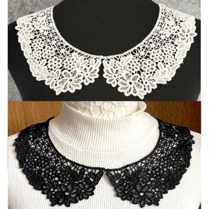 May include: Two lace collars, one white and one black. Both collars have a scalloped edge and a floral design.