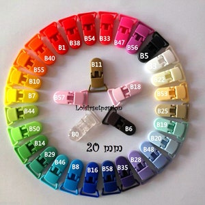 May include: Assortment of 20 mm plastic clips in various colors, including red, orange, yellow, green, blue, purple, pink, white, brown, and black. The clips are arranged in a circle with the color names and numbers printed on each clip.