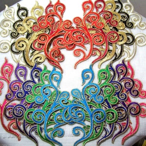 May include: Assortment of colorful embroidered fabric appliques with gold trim. The appliques feature a swirling, floral design.