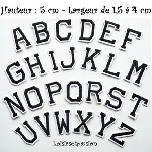 May include: A set of black and white embroidered alphabet letter patches arranged in rows. Each letter features a bold block font with a white border. The text at the top indicates a height of 5 cm and a width of 1.5 to 4 cm for each letter.