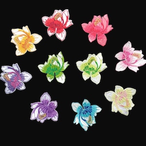 May include: A collection of ten embroidered flower patches in various colors, including yellow, red, pink, green, purple, and blue. Each patch features detailed stitching and a white border, set against a black background.