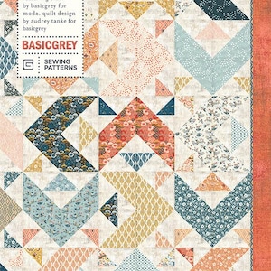 May include: A patchwork quilt with a geometric design in shades of blue, peach, yellow, and white. The quilt features arrow and triangle shapes, with the text "APPLE SEED PAT029" and "BASICGREY SEWING PATTERNS".