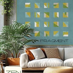 May include: A teal wall hanging with a geometric design of squares in yellow, green, and white. The word "FRAGMENT" is below the design. The image also shows a white sofa with pillows, a woven ottoman, and potted plants.