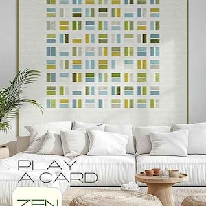 May include: A white couch with pillows in a living room setting. A framed abstract art print with green, blue, and yellow squares hangs on the wall above the couch. A round, woven ottoman sits in front of the couch. The text "PLAY A CARD" is in front of the couch. A square logo with the text "ZEN CHIC" and the name "BRIGITTE HEITLAND" is below the ottoman.