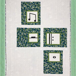 May include: A quilt pattern called "Notation" with a green and white background and four squares with musical notes in black and white. The quilt is 60 inches by 77 inches. The text "Everyday Stitches" and "Patterns for everyday life" is at the bottom of the quilt.