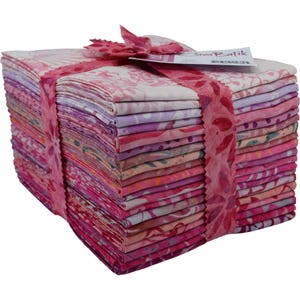 May include: A stack of pink and white batik fabric squares, tied together with a pink ribbon. The fabric is arranged in a neat pile, and the ribbon is tied in a bow at the top. The fabric is a mix of different patterns, including floral, geometric, and abstract designs. The fabric is a soft, lightweight material that is perfect for quilting, sewing, and crafting.