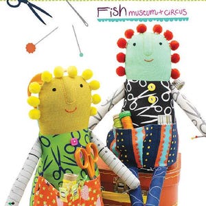 May include: A quilt pattern titled "Sewing Fairy" by Deborah Fisher of Fish Museum + Circus. The image features two whimsical fabric dolls, approximately 16 inches tall, with colorful details, including scissors, pockets, and pom-pom accents.