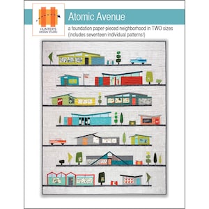 May include: A quilt featuring a colorful, mid-century modern neighborhood design. The quilt includes various houses, trees, and cars, with the text "Atomic Avenue" and "HUNTER'S DESIGN STUDIO". The design is a foundation paper-pieced neighborhood in two sizes.