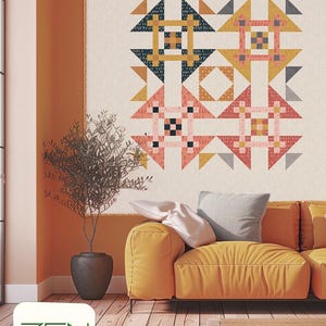 May include: A colorful quilt with geometric patterns in shades of pink, yellow, navy, and gray hangs on a wall. The quilt is above a yellow sofa with gray and white pillows. The word "FUSION" is displayed below the quilt.