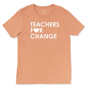 May include: A peach-colored t-shirt with the text "TEACHERS FOR CHANGE" in white with a white heart replacing the "O" in "FOR".