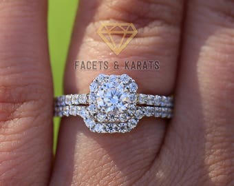 May include: A diamond engagement ring set with a square halo setting and a matching wedding band. The ring is set in white gold and features a large, round centre diamond.