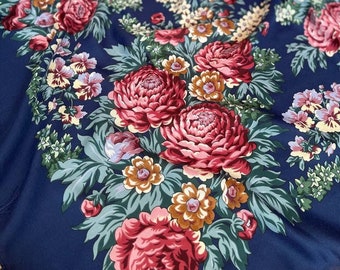 May include: A navy blue fabric with a floral pattern. The pattern features pink, red, and white flowers with green leaves. The fabric is soft and silky.