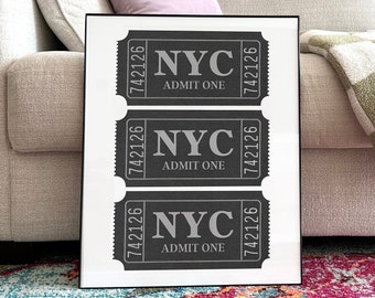 May include: Three black and white ticket-shaped prints with the text "NYC" and "ADMIT ONE" on each. The tickets are framed in a black frame.
