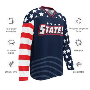 May include: A navy blue long-sleeved jersey with a red, white, and blue American flag design. The jersey has the word "STATES" printed on the front in red and white letters. The jersey is made of recycled polyester fabric and is breathable and has a UPF 50+ rating.