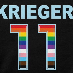 May include: Black jersey with the name "KRIEGER" in light blue lettering and the number "11" in a rainbow color scheme with a light blue outline.