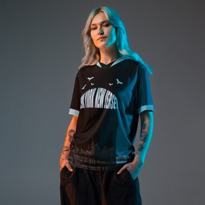 K&ouml;nnte beinhalten: Ein schwarzes T-Shirt mit kurzen &Auml;rmeln und einem wei&szlig;en Grafikdruck einer Stadtlandschaft und dem Text "New York New Jersey". Die Grafik enth&auml;lt auch Flederm&auml;use.