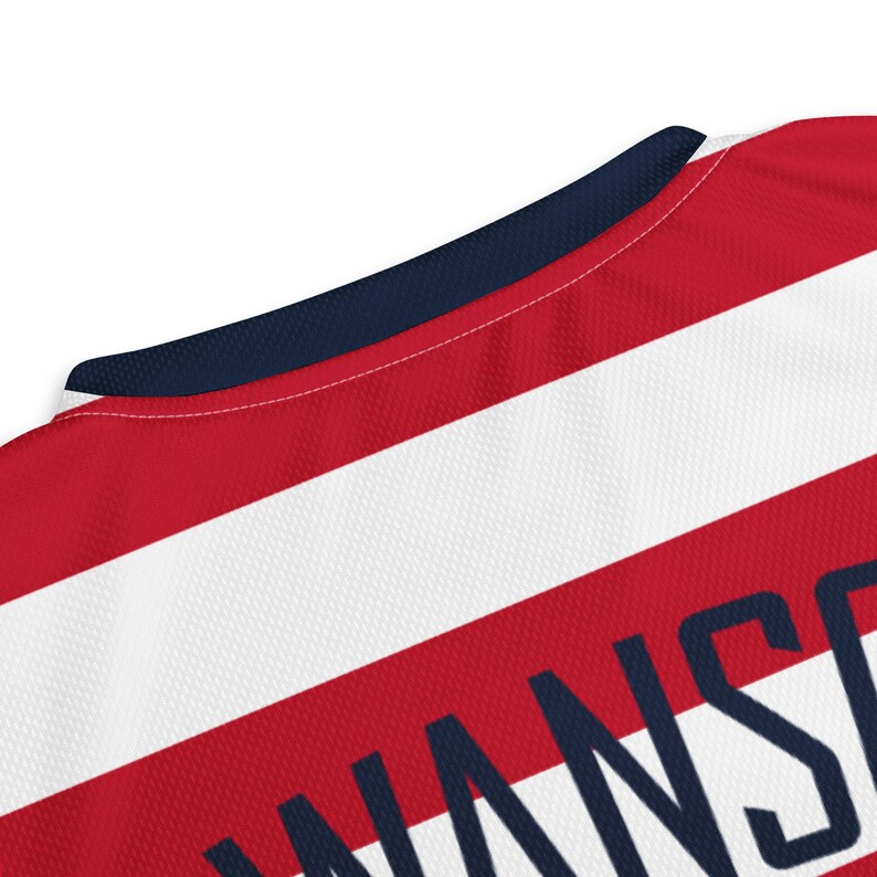 May include: Red and white striped jersey with a navy blue collar and the word "WANS" printed in navy blue on the back.