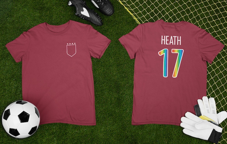 May include: A maroon soccer jersey with a white shield and stars on the front and the name "Heath" and the number "17" in rainbow colors on the back.