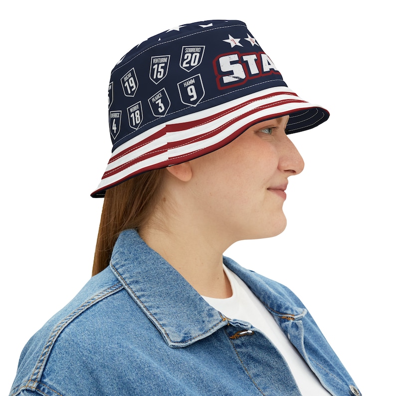 May include: A blue and red bucket hat with a white star and the word "STAR" printed on the front. The hat also features a design of various numbers and words on the front.