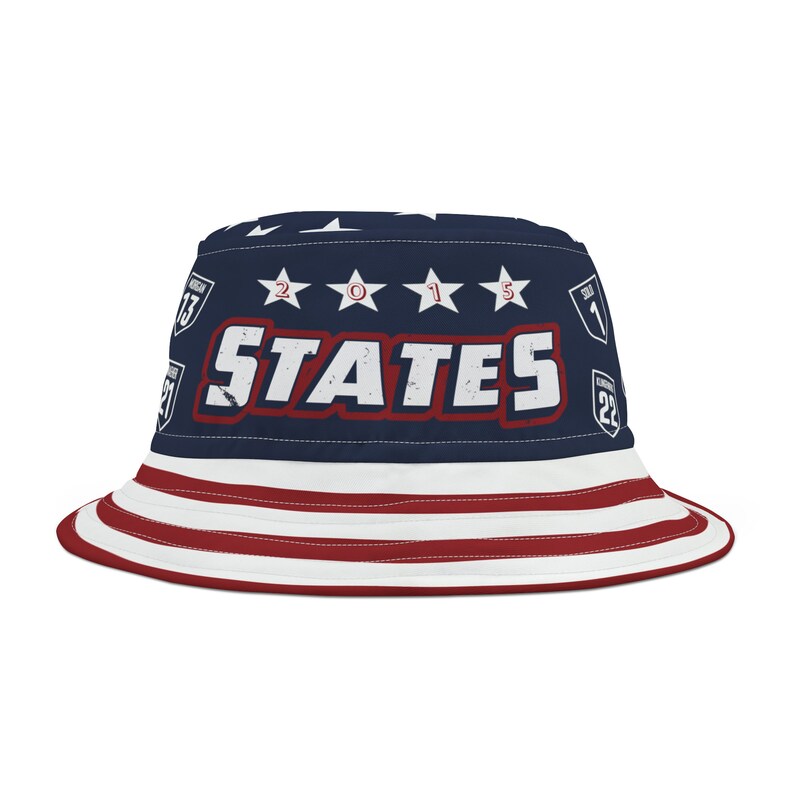 May include: A blue and red bucket hat with a white star pattern and the text "STATES" in red with white stars above the text. The hat also has the numbers "2015" in white.