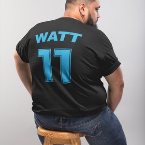 May include: Black t-shirt with the text "WATT 11" in blue on the back.
