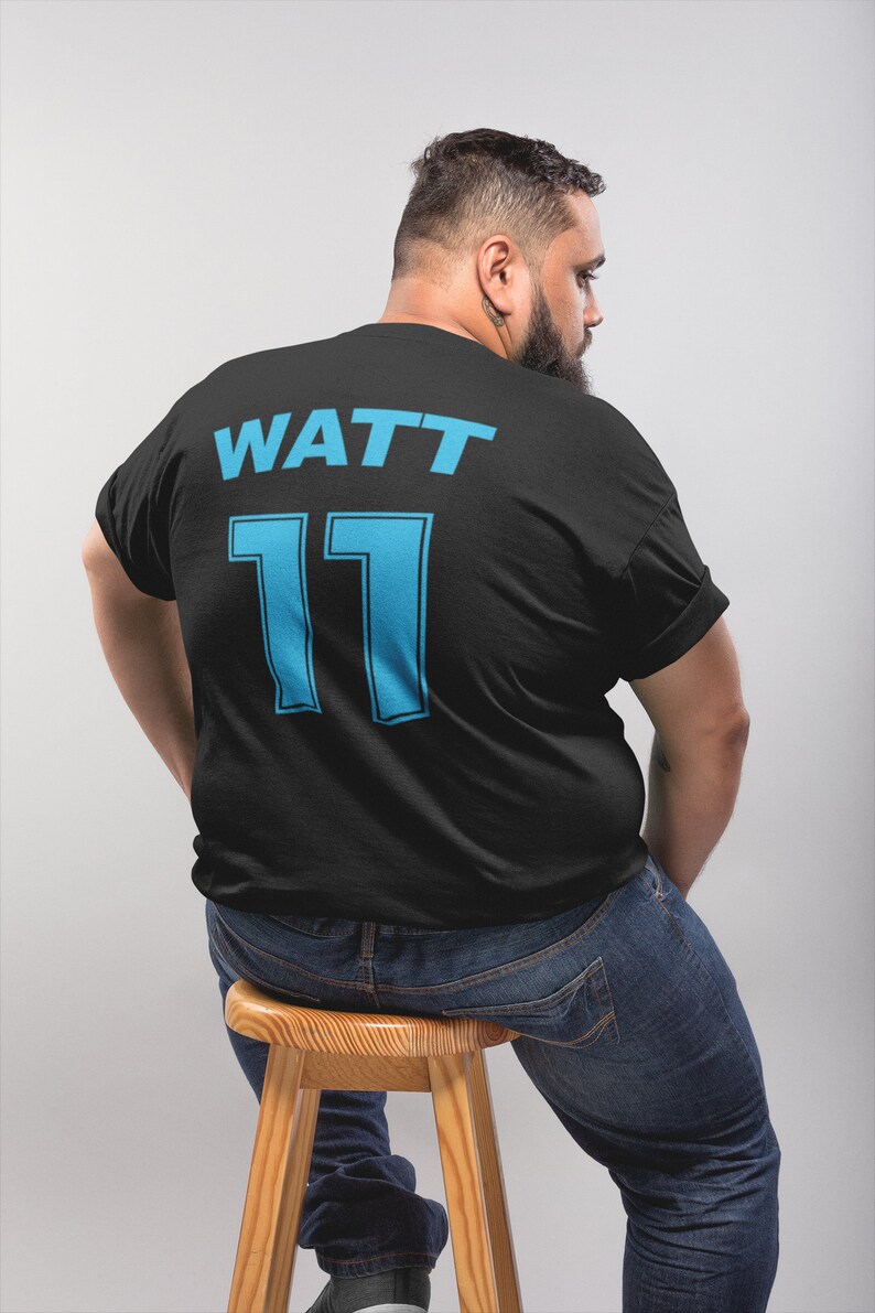May include: Black t-shirt with the text "WATT 11" in blue on the back.