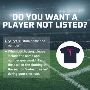 May include: A graphic with a soccer field background and text that reads "Do you want a player not listed?" with instructions to select "custom name and number" and to include the name and number in the notes to seller section at checkout. The graphic also shows a black t-shirt with a white number 1 and the word "Sheridan" in pink.