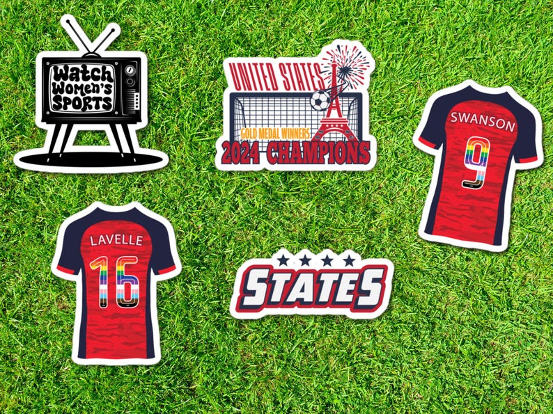 May include: Four stickers featuring a television with the text "Watch Women's Sports", a soccer jersey with the number 9 and the text "SWANSON", a soccer jersey with the number 15 and the text "LAVELLE", and a soccer goal with the text "UNITED STATES GOLD MEDAL WINNERS 2024 CHAMPIONS" and a sticker with the text "STATES" with five stars.