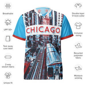 Op de afbeelding: Een blauw en wit T-shirt met een afbeelding van een trein en het woord "CHICAGO" erop gedrukt. Het shirt heeft een V-hals en korte mouwen.