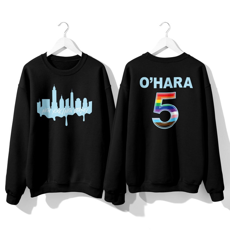May include: Two black sweatshirts. One sweatshirt has a blue outline of the New York City skyline with the text "New York/New Jersey". The other sweatshirt has the text "O'HARA" and the number "5" with a rainbow design.