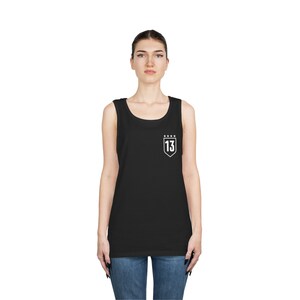 May include: Black sleeveless tank top with a white shield design featuring the number "13" and five stars.