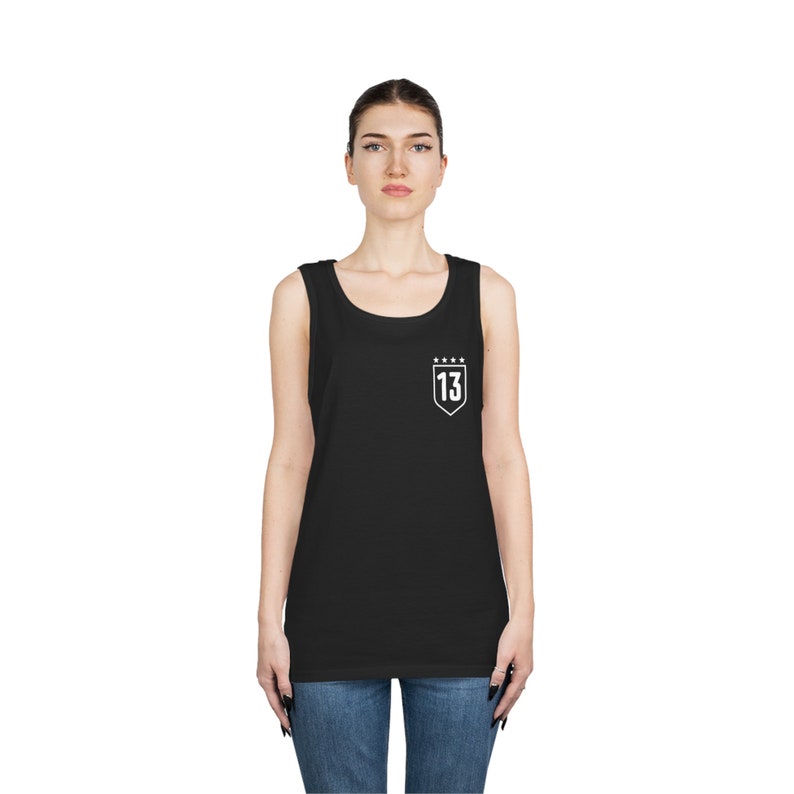 May include: Black sleeveless tank top with a white shield design featuring the number "13" and five stars.