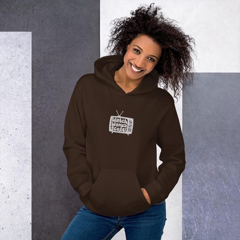 May include: A brown hoodie with a white graphic of a television screen with the text "Watch Women Score!" on it.