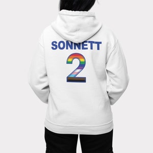May include: White hoodie with a blue "SONNETT" text and a rainbow-colored number "2" on the back.