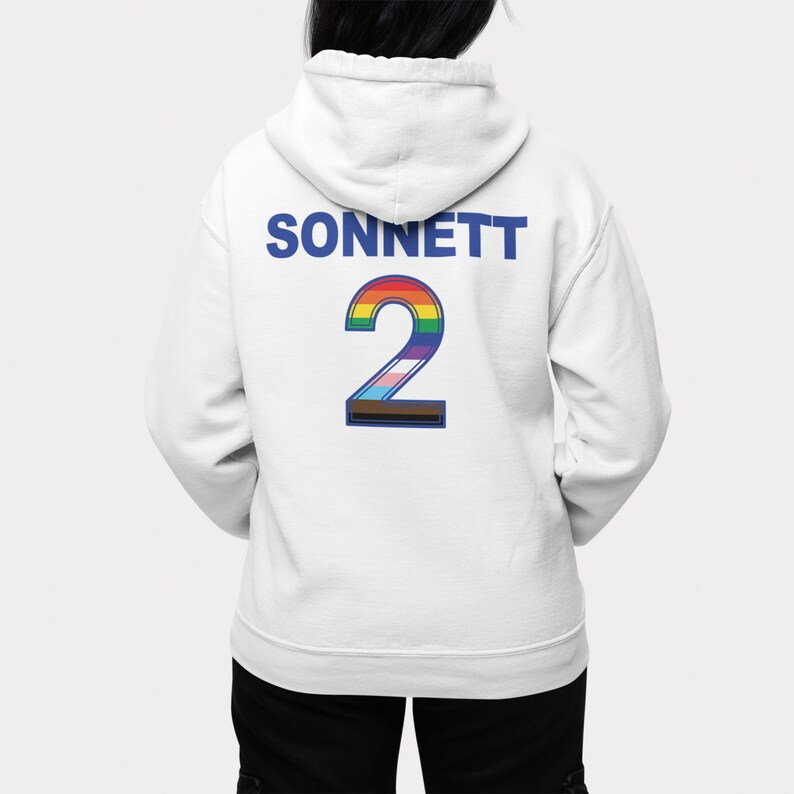May include: White hoodie with a blue "SONNETT" text and a rainbow-colored number "2" on the back.